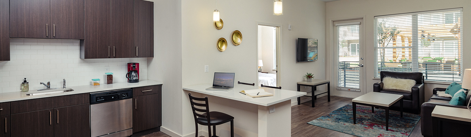 View of furnished apartment kitchen and living room